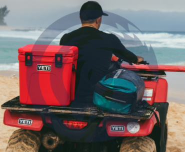 YETI cooler on a quad with a man on the beach.